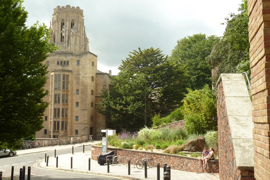 Wills building from Cantocks Close. two students sit and chat in the forground. 